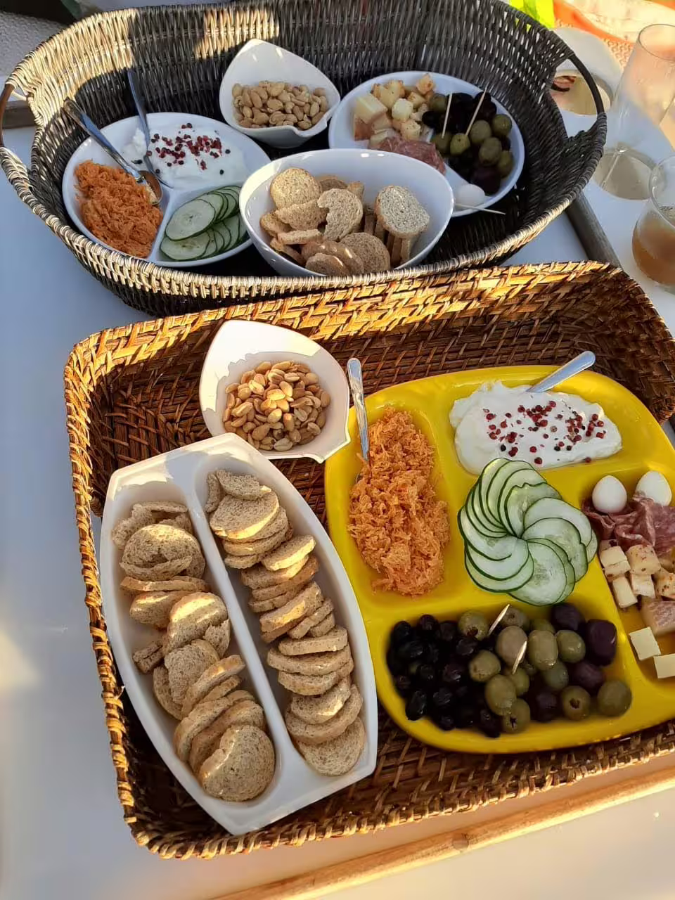 Gourmet breakfast spread with breads, cheeses, and fresh produce aboard a sailing tour.