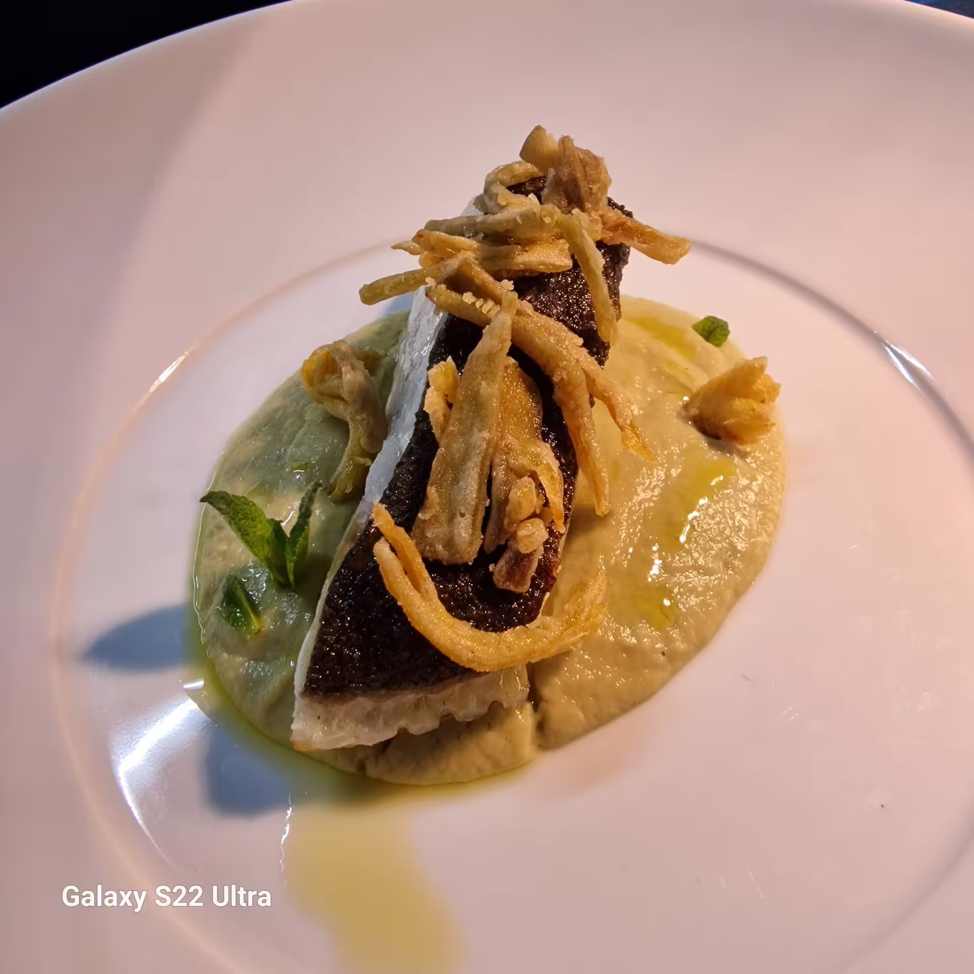 Gourmet fish fillet with crispy onions on creamy puree at chef Angelo Lanaro’s home restaurant