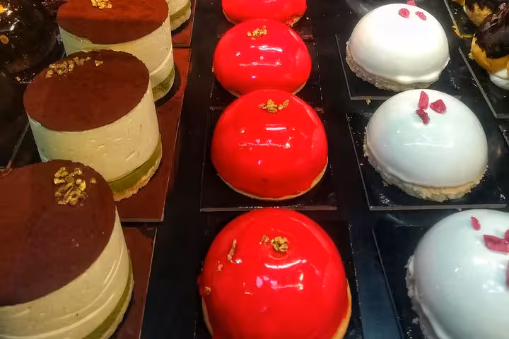 Assorted gourmet Italian pastries with vibrant colors, featured on the Pope's favorite food tour in Rome.