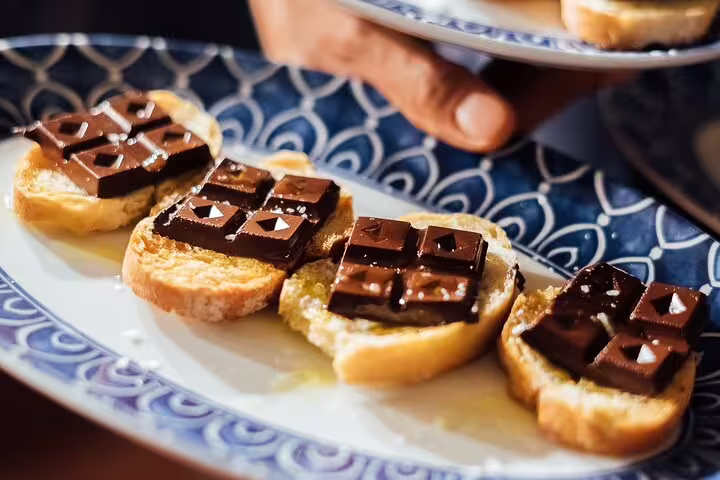 Gourmet tapas featuring chocolate-topped toast served on a decorative plate during a private wine tour.