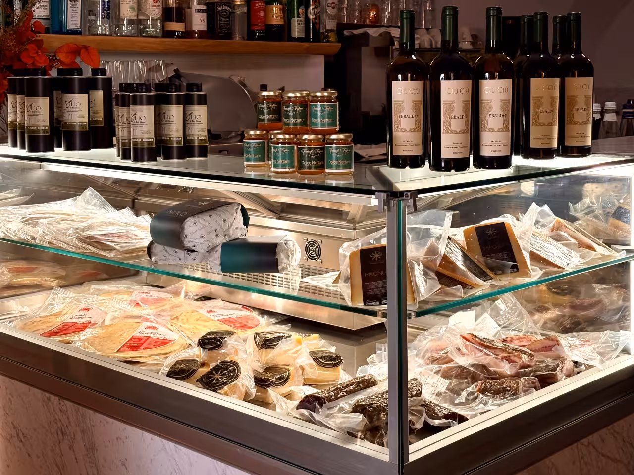 Gradara food tasting display with Marche wines, extra virgin olive oil, local cheeses and cured meats