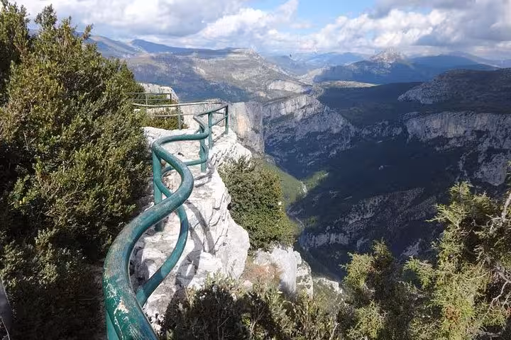 Breathtaking cliffside view with railing overlooking vast landscapes in the Grand Canyon of Europe.