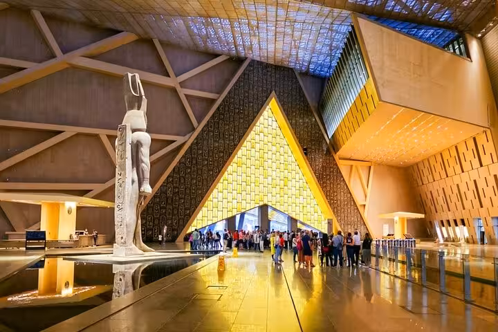 Grand Egyptian Museum Cairo interior with statues and modern atrium, key stop on Hurghada to Cairo tour