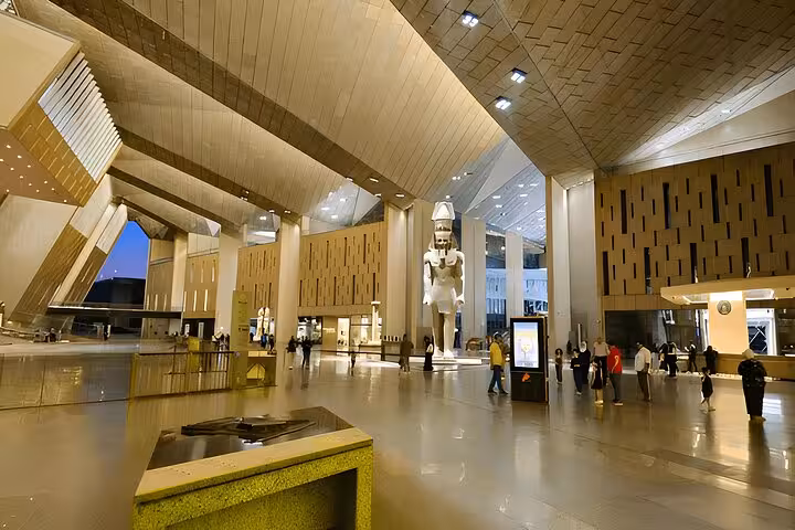 Grand Egyptian Museum Cairo atrium with towering pharaoh statue, highlight of 3-day Cairo tour