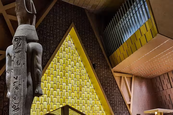 Grand Egyptian Museum Cairo interior with pharaoh statue and golden geometric wall, QR ticket entry tour