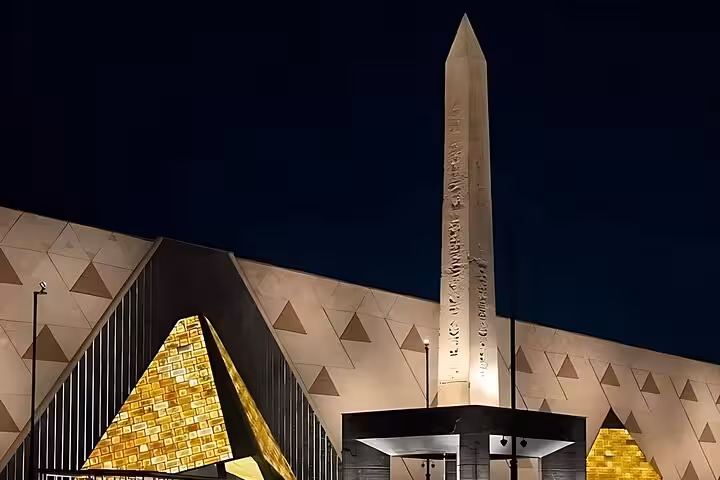 Grand Egyptian Museum exterior at night in Cairo with obelisk and pyramid facade, QR ticket tour