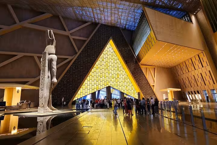 Grand Egyptian Museum entrance hall with towering statue and modern architecture on Cairo guided tour