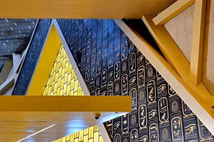 Grand Egyptian Museum Giza interior with hieroglyphic wall and modern architecture on private Cairo day tour