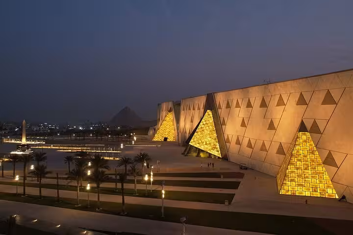 Grand Egyptian Museum exterior at dusk near Giza Pyramids, featured on VIP Giza & GEM guided tour