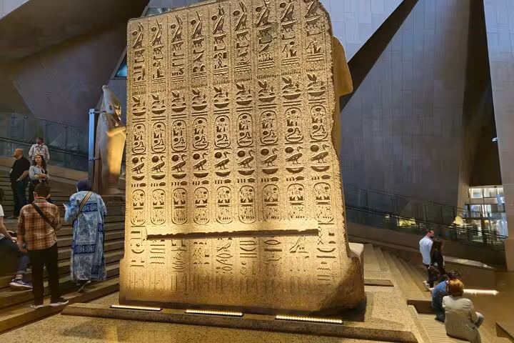Hieroglyphic stone stele inside the Grand Egyptian Museum Cairo, entry with QR ticket and transfer option