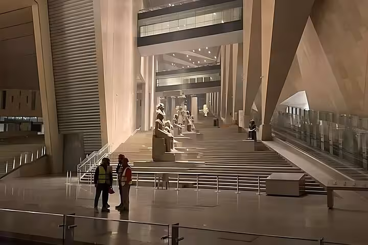 Grand Egyptian Museum interior atrium in Cairo with statues and steps, ideal for QR ticket entry