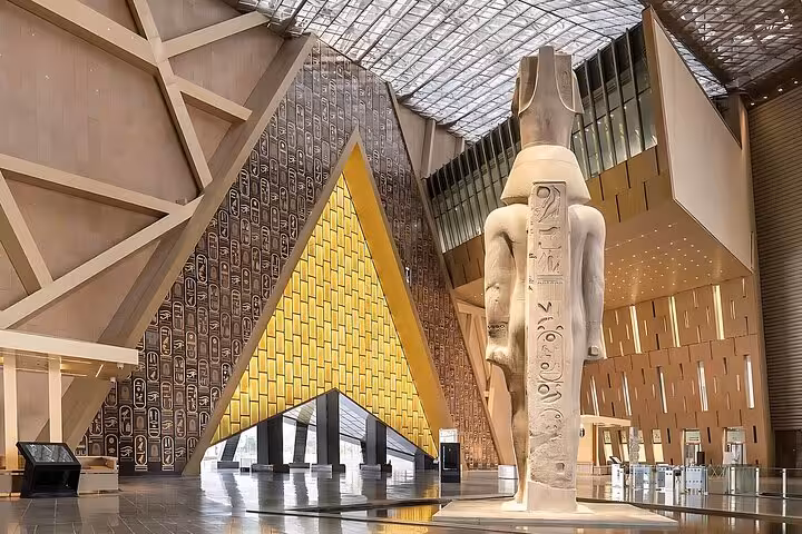 Grand Egyptian Museum atrium with colossal pharaoh statue, highlight on Sharm to Cairo air tour
