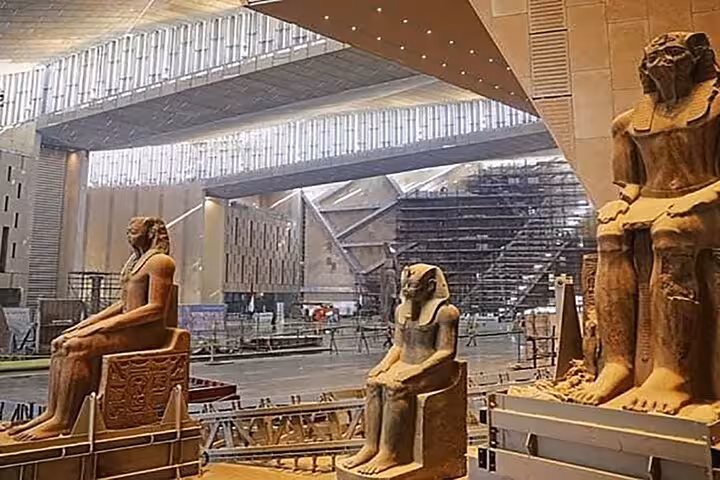 Grand Egyptian Museum interior with colossal pharaoh statues, featured on Giza Pyramids day tour Cairo