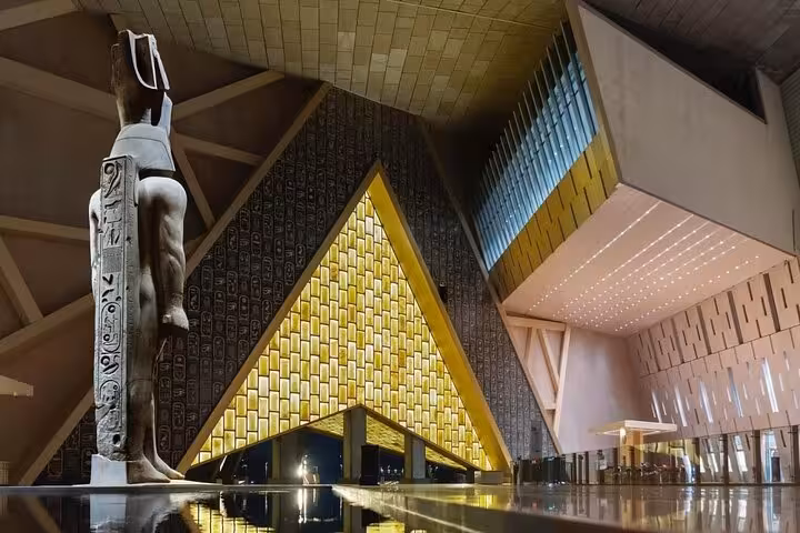 Grand Egyptian Museum entrance with towering Ramses II statue, featured on Cairo to Giza pyramids tour