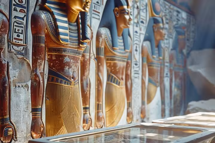 Colorful ancient Egyptian temple reliefs and statues at Grand Egyptian Museum Cairo on pyramids tour