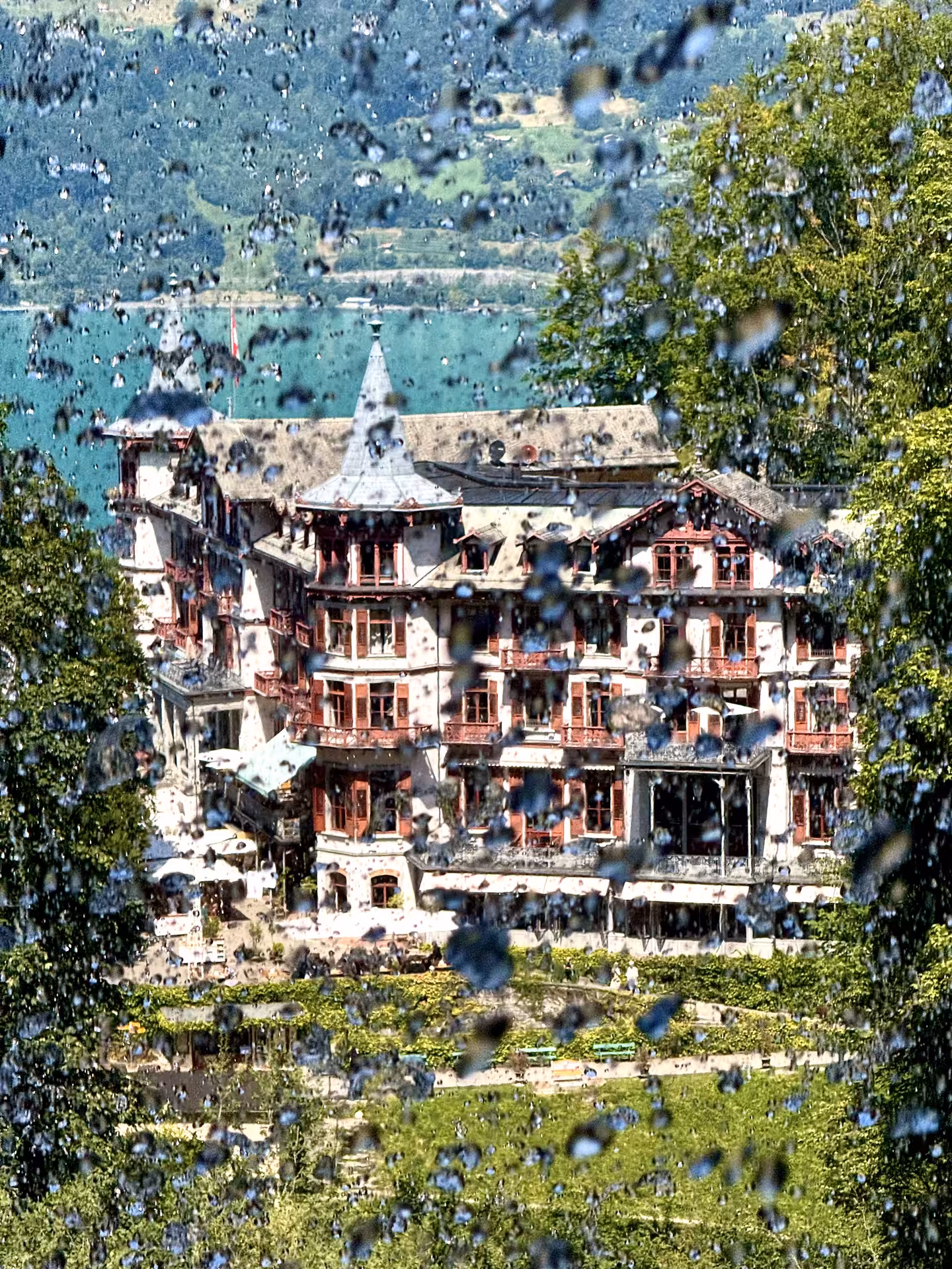 Grand Hotel Giessbach seen through waterfall spray above Lake Brienz on Iseltwald & Giessbach e-bike tour