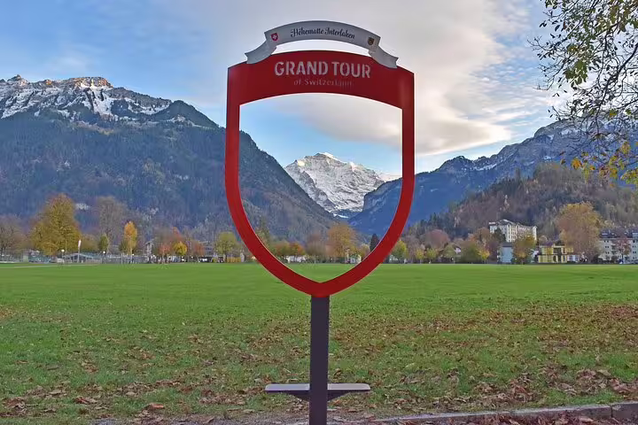 Grand Tour of Switzerland sign with stunning alpine backdrop on exclusive panoramic train journey.