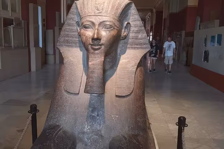Granite pharaoh statue in the Egyptian Museum Cairo gallery, a highlight of Giza Pyramids day tour