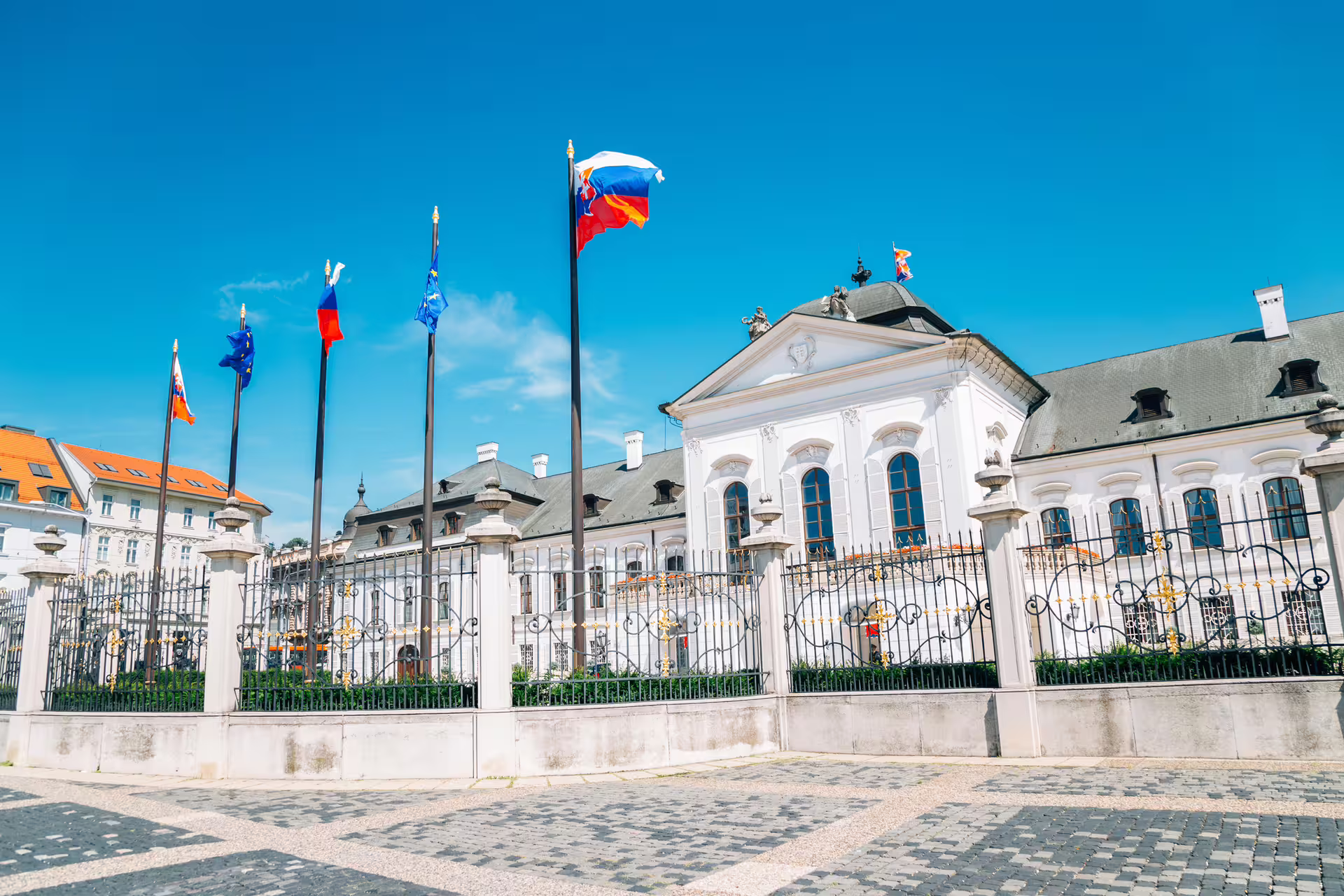 Grassalkovich Palace in Bratislava historic center with Slovak flags, featured on 1-day walking tour audioguide