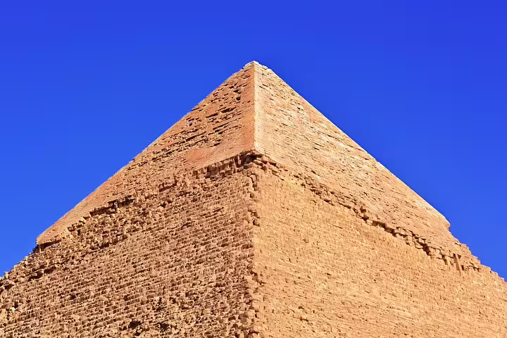 Close-up of the Great Pyramid of Giza under blue sky, highlight of Cairo day tour with camel ride