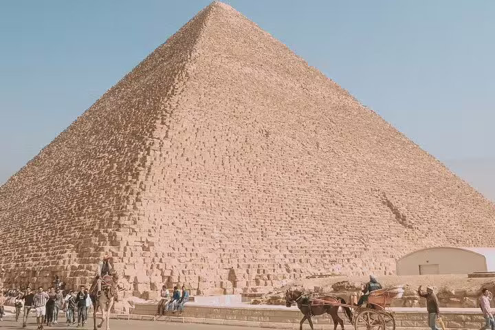 Great Pyramid of Giza with camel rides and visitors, classic Cairo day trip from Port Said to pyramids tour