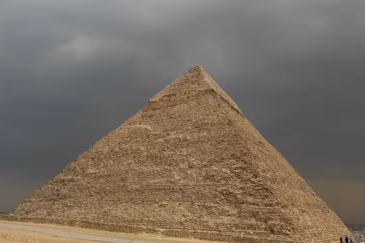 Close-up view of the Great Pyramid of Giza under dramatic skies on a private pyramids and Sphinx tour