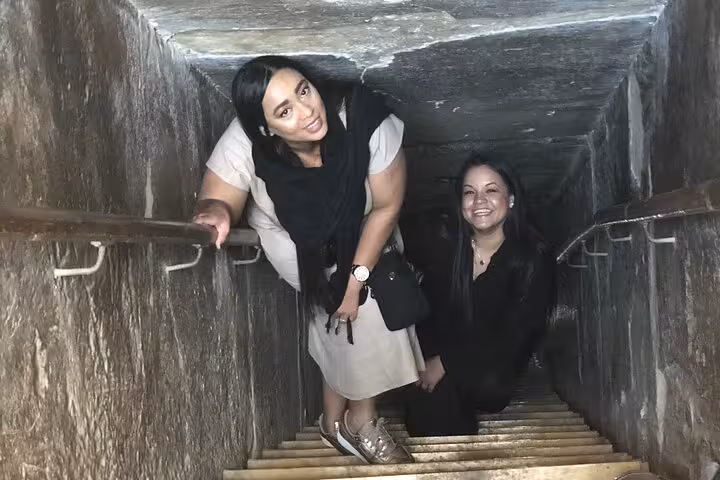 Visitors descending narrow passage inside the Great Pyramid of Giza, Cairo 2-day pyramids tour experience