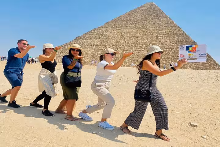 Tourists posing for a fun photo at the Great Pyramid of Giza, part of Giza Pyramids, GEM and Khan ElKhalili day tour