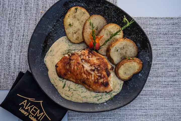 Great Pyramid Inn dinner plate with grilled chicken and potatoes, part of Giza sunset camel ride tour