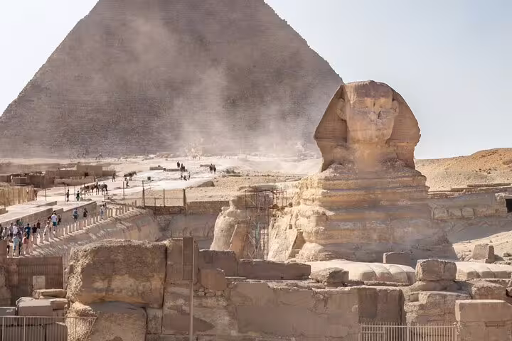Close view of the Great Sphinx with pyramid backdrop, classic photo spot on Giza Pyramids and Egyptian Museum day tour