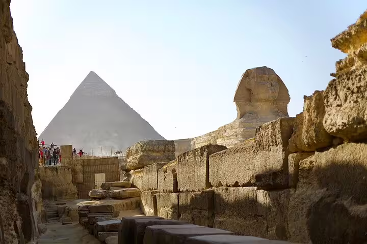 Great Sphinx and Giza Pyramid view from ancient stone passage on private Giza Pyramids tour in Cairo