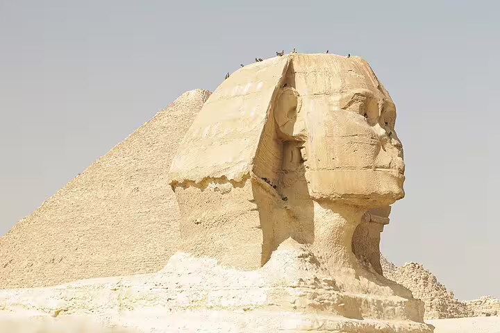 Great Sphinx of Giza close-up with pyramid behind, private tour from Cairo to iconic ancient Egypt sites