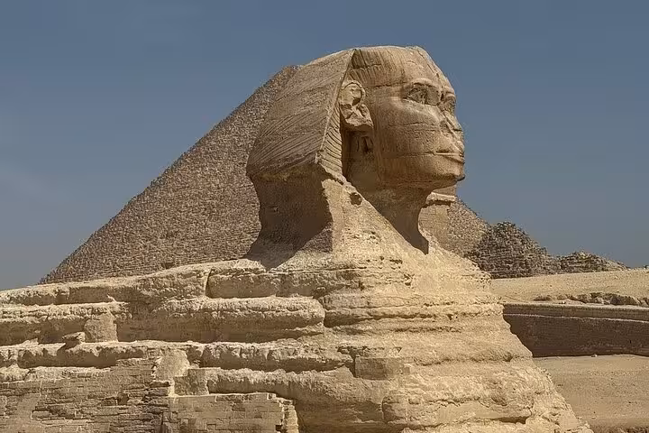 Great Sphinx with Pyramid of Khafre behind, iconic stop on Giza Pyramids tour in Cairo, Egypt