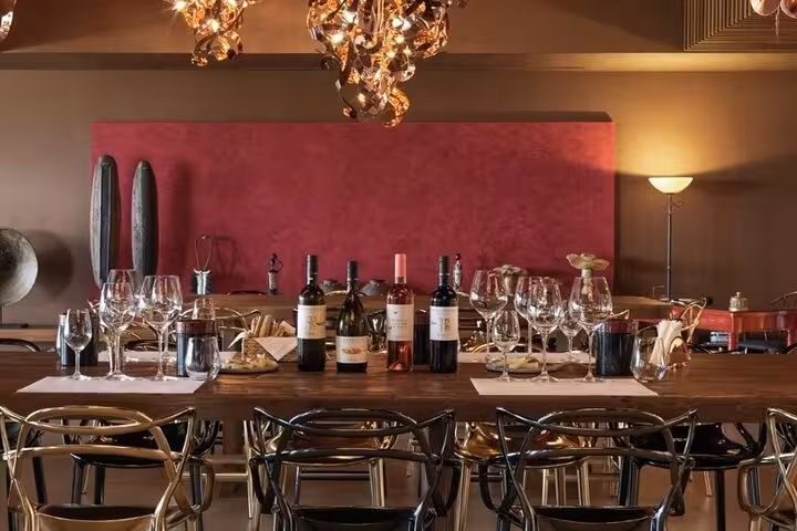 Wine tasting table set with Greek bottles and glasses, ideal for Athens Nemea Santorini Greece Wine Roads tour