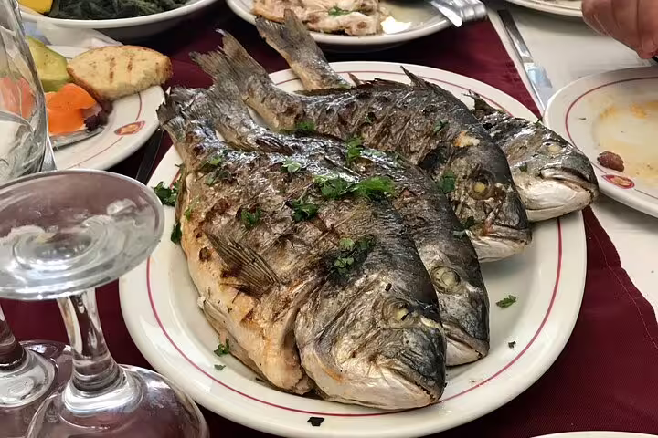 Greek taverna grilled fish lunch paired with extra virgin olive oil tasting near Nafplio and Corinth Canal