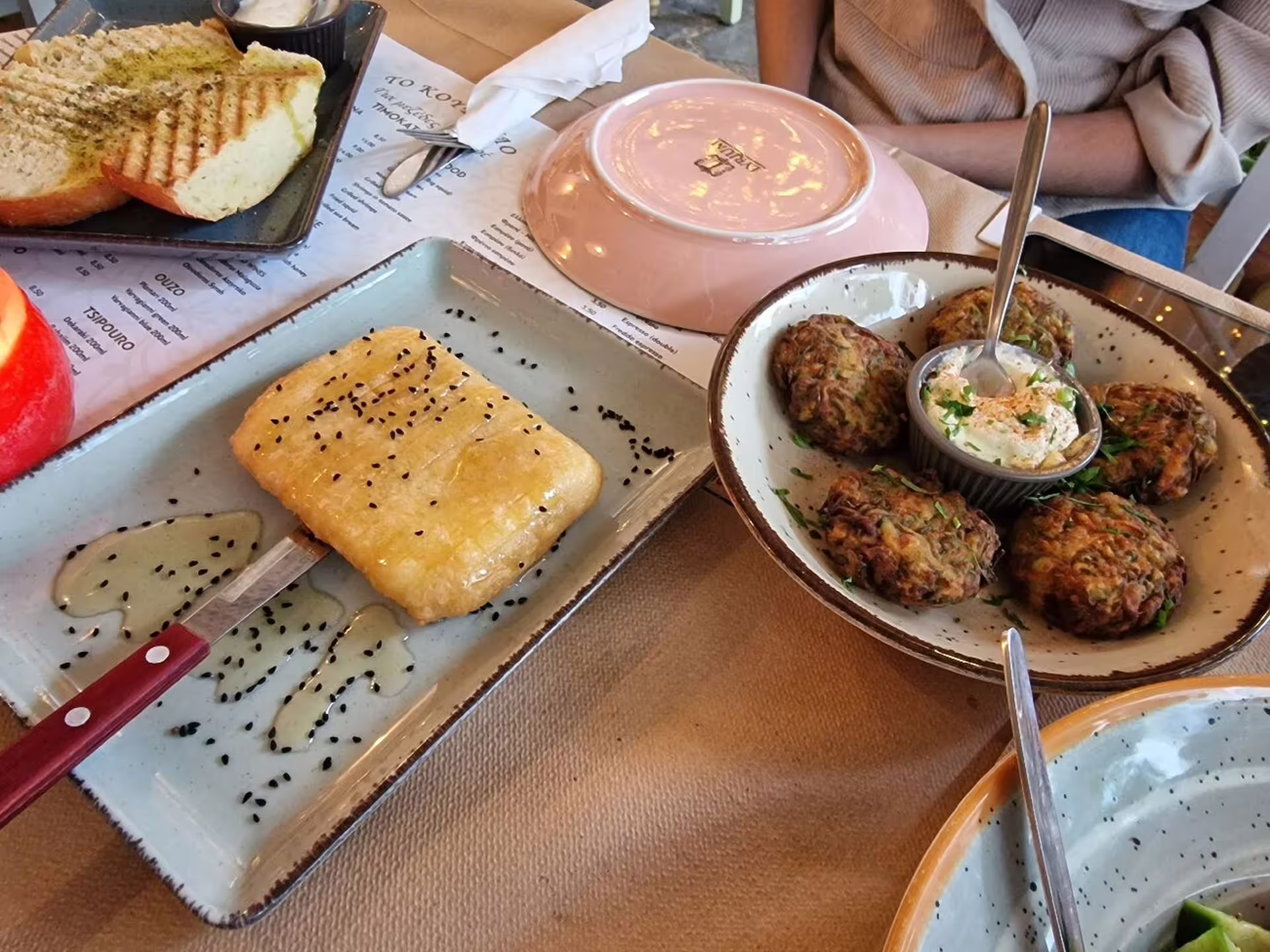 Greek meze tasting with zucchini fritters, dip and honey pastry during a Taste of Athens small-group afternoon food tour