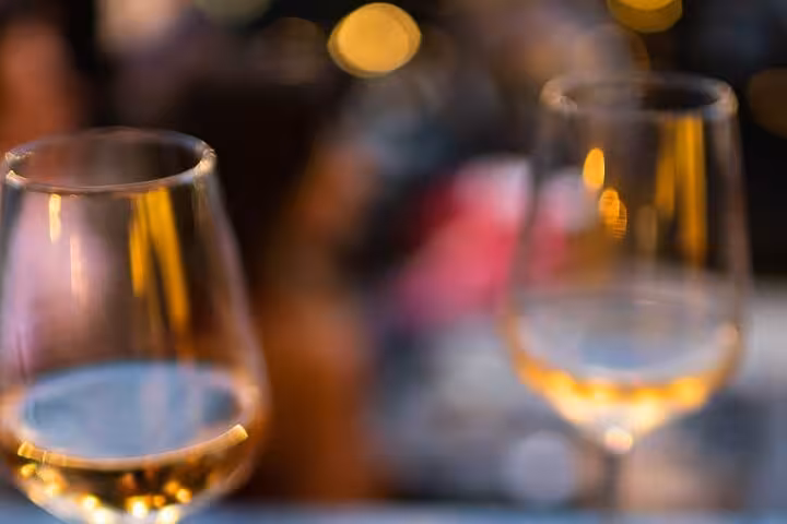 Close-up of Greek white wine glasses at an Athens private wine tasting experience led by a licensed wine guide