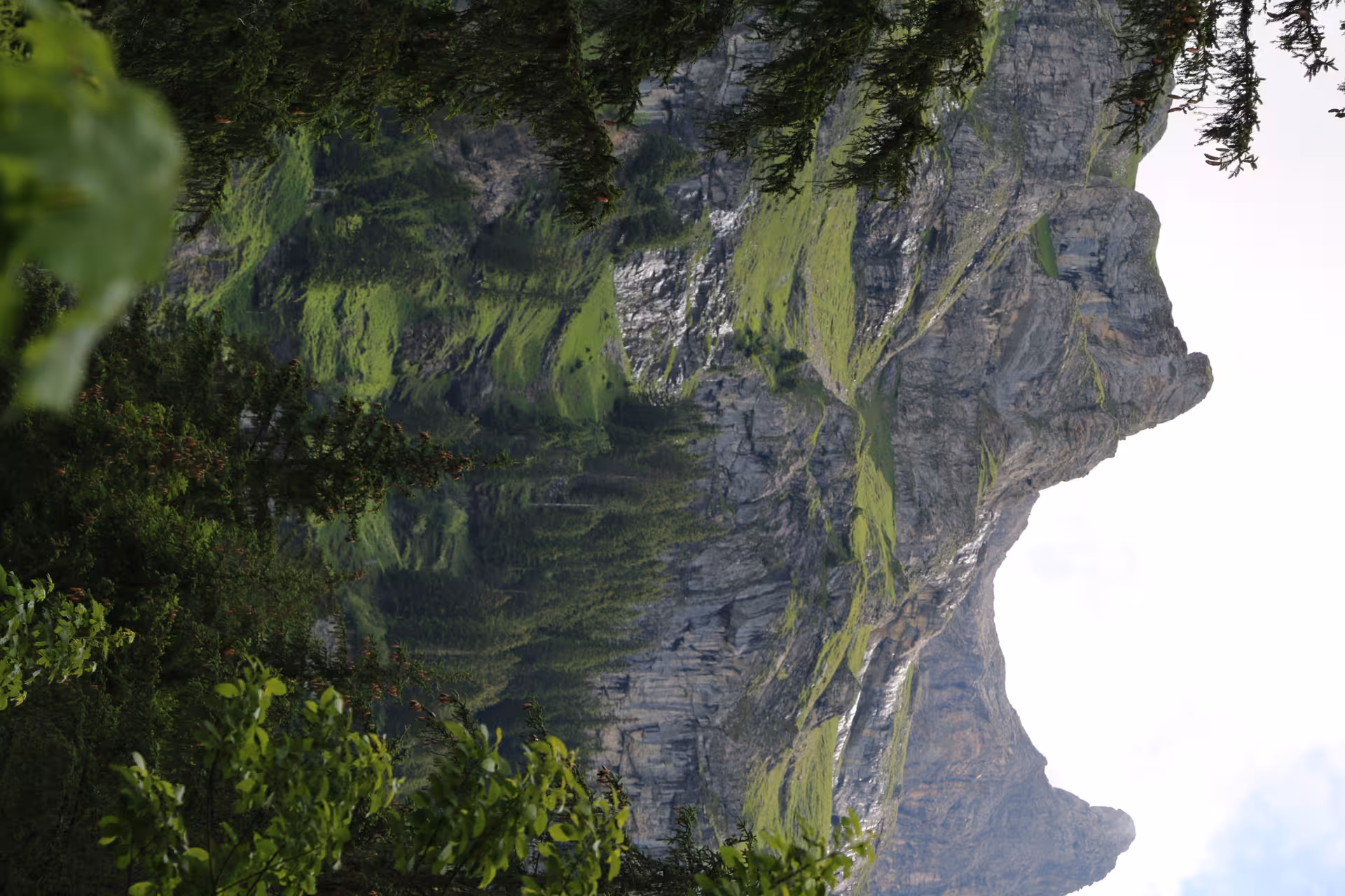 Green cliffs and rugged peaks above Griesalp UNESCO alpine valley, Switzerland, panorama from e-bike route