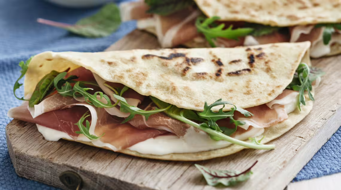 Grilled piadina with prosciutto, arugula and cheese, part of Rimini Piadina Museum tour with lunch/dinner