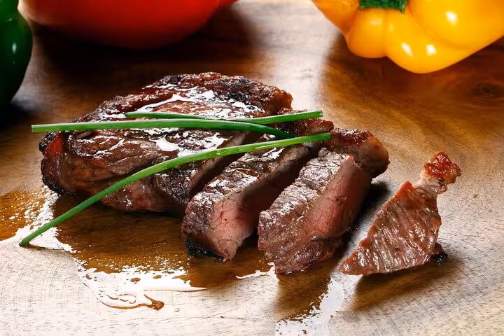 Juicy grilled steak with fresh vegetables, part of Rio's Cookin' Good 9-dish culinary experience.