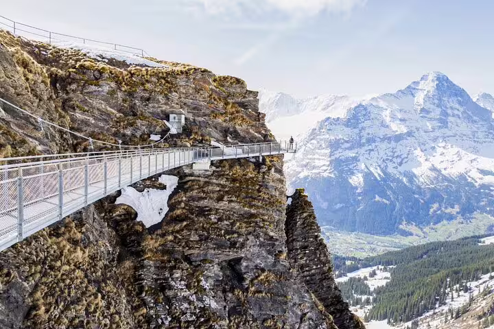 Suspended cliff walk offering stunning panoramic views of the Swiss Alps during the Grindelwald First Adventure Tour.