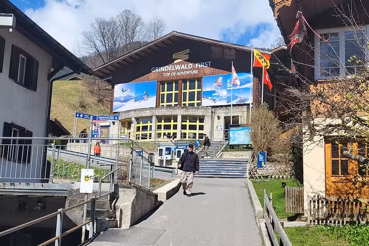 Grindelwald First adventure hub with Swiss flags and scenic backdrop in the heart of the Swiss Alps.