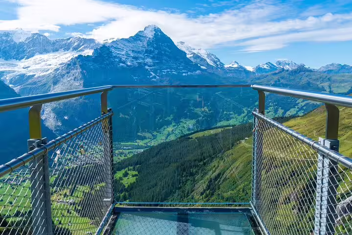 Breathtaking view from a glass observation deck overlooking the majestic Swiss Alps on the Grindelwald First Tour.