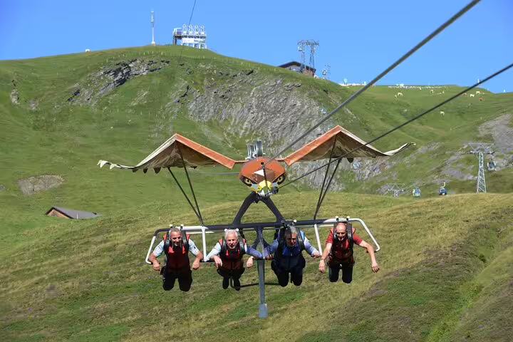 Adventurers experience thrilling zipline ride at Grindelwald First on an exciting day tour from Zurich.