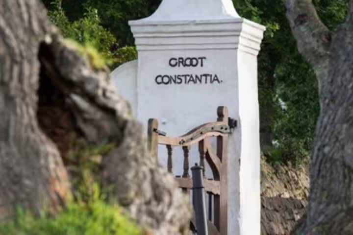 Historic entrance to Groot Constantia, South Africa's oldest wine estate, on a Cape Town day tour.