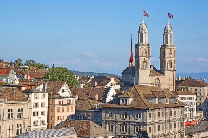 Historic Grossmünster Church towers over Zurich's old town on a sunny day, perfect for a half-day city exploration.