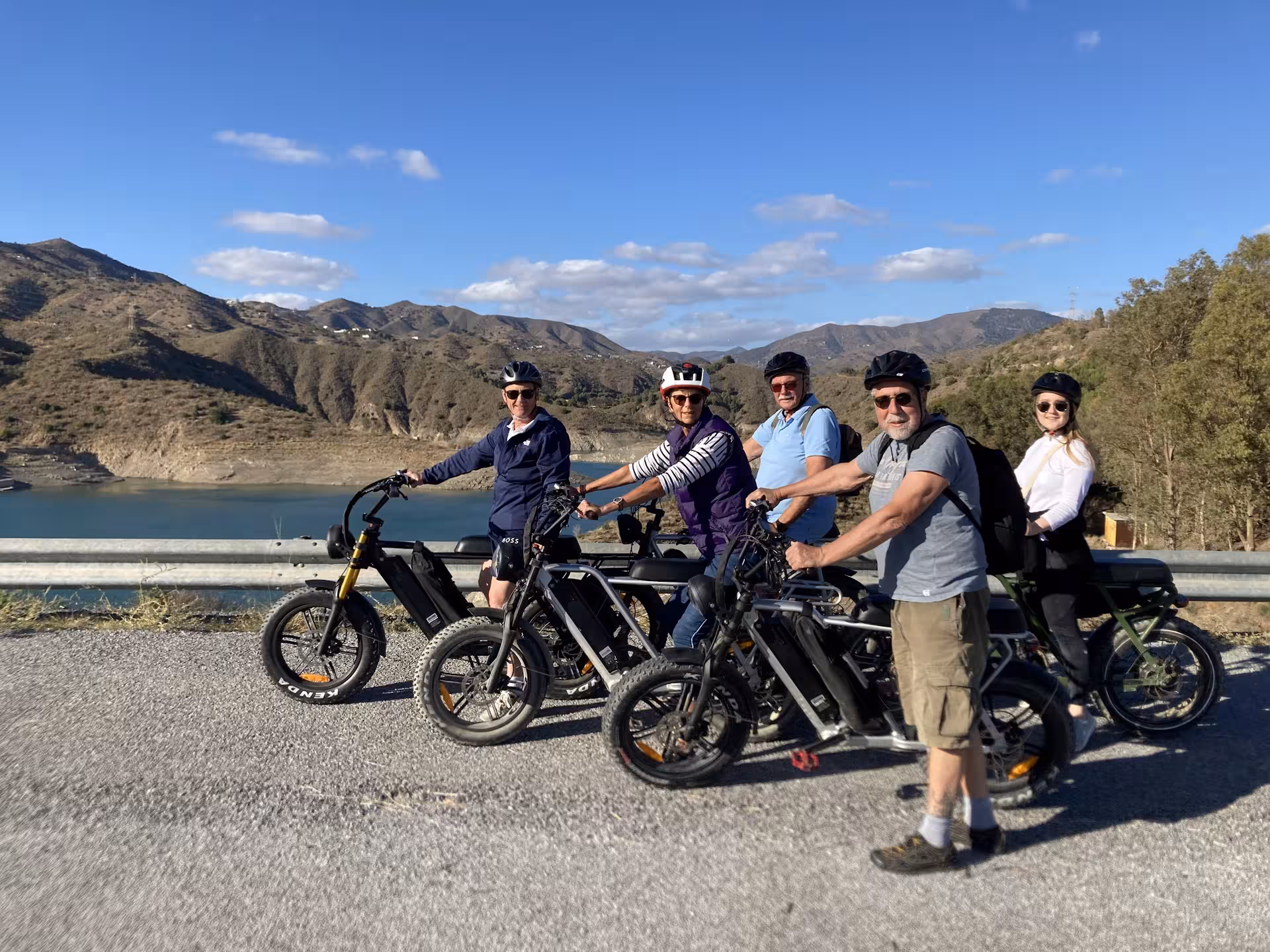 Group on e-fat bikes at mountain lake viewpoint, enjoying a 4-hour e-bike rental for trails and coastal views