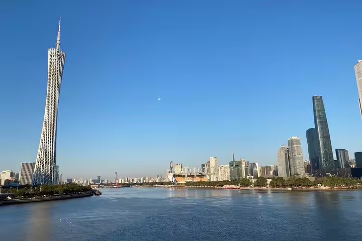 Stunning view of Guangzhou skyline with Canton Tower overlooking the Pearl River on a clear day.