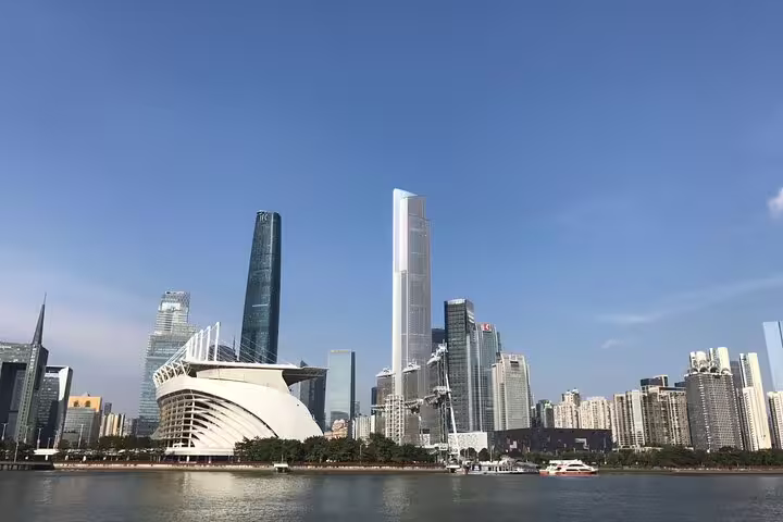 Panoramic skyline view of Guangzhou's modern skyscrapers and waterfront, ideal for a daytime city tour.