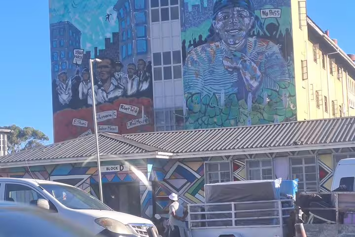 Colorful mural in Gugulethu depicting historical figures and community life, featured in Cape Town township tours.